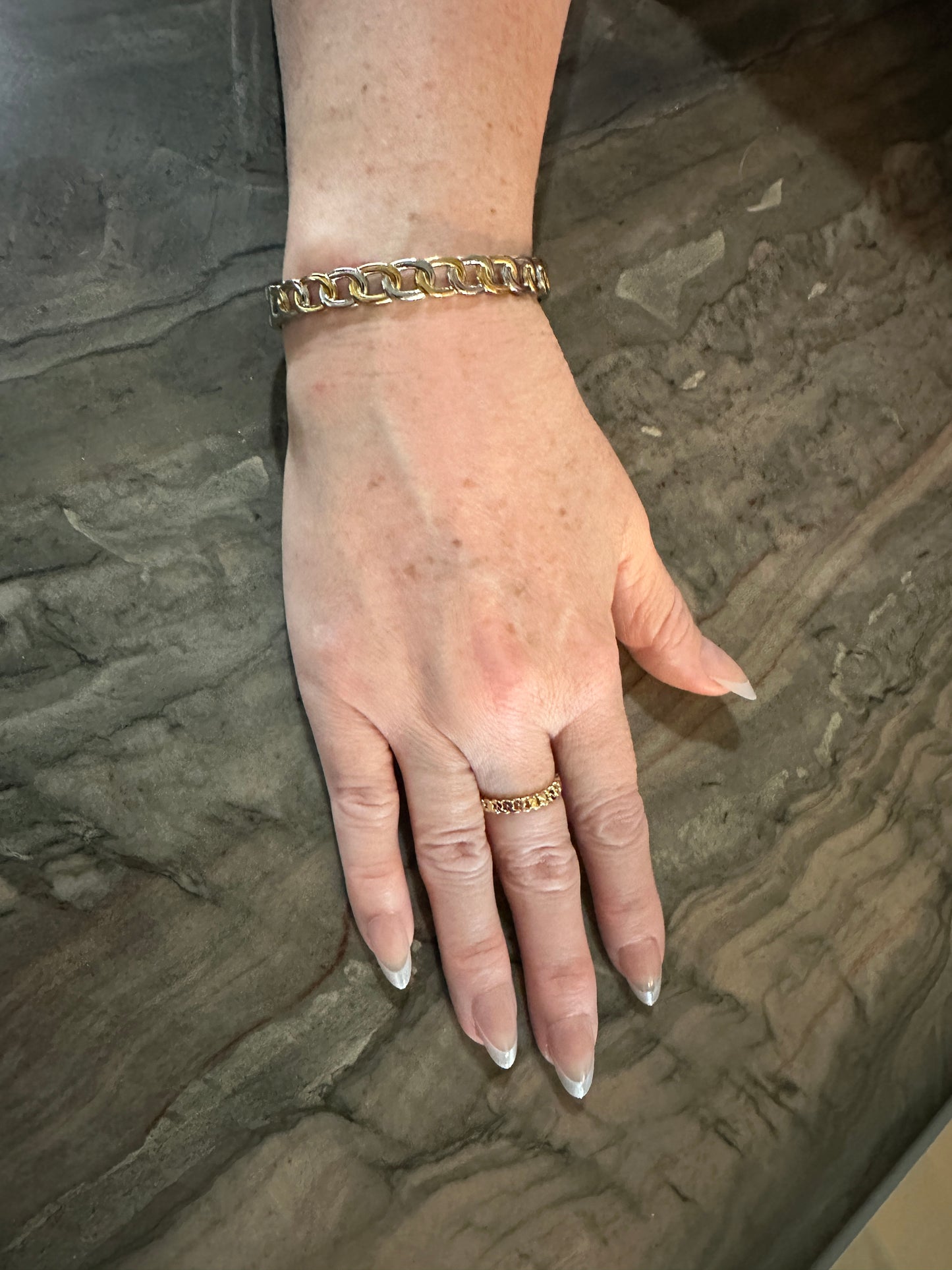 The Olivia Bangle Bracelet, modeled with the Cora Cuban Chain Ring