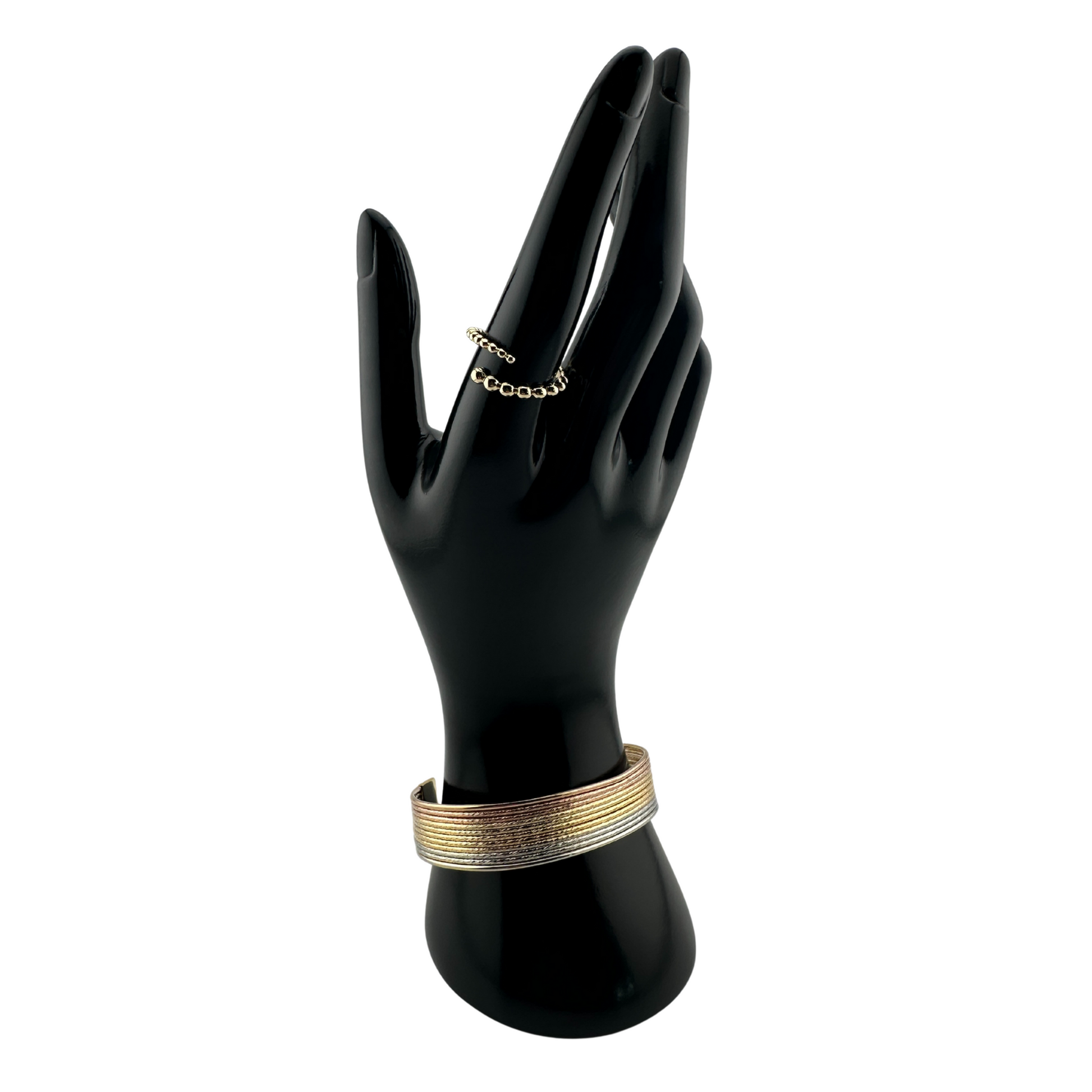 The Siena Diamond-Cut Tri-Tone Stackable Cuff Bracelet, shown on mannequin hand with The Noemi Beaded Spiral Adjustable Ring