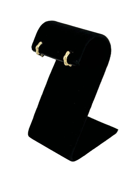 The Berneda Bamboo Clicker Huggie Earrings, side view on black velvet earring stand with white background