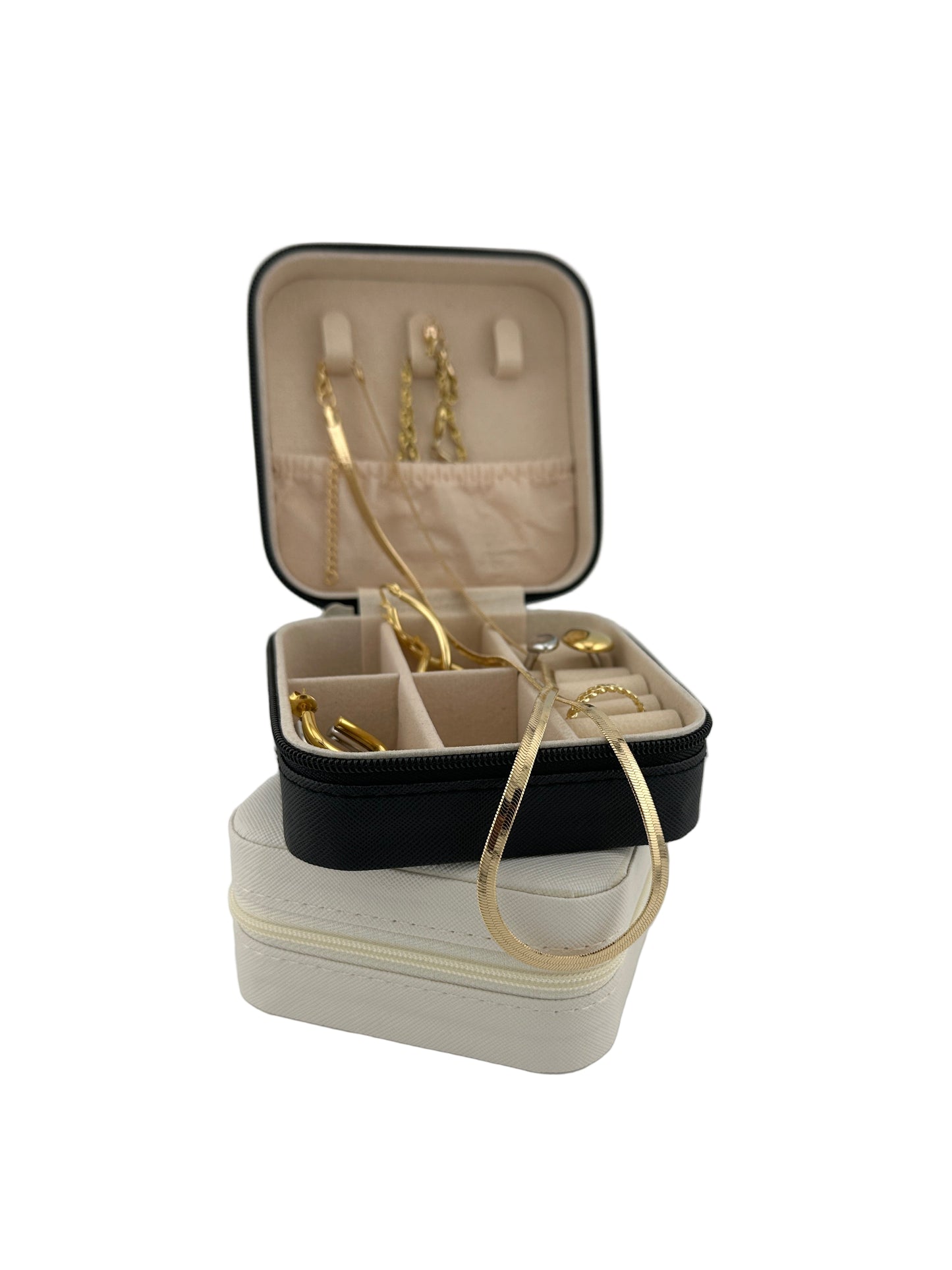 The Jet Jewelry Travel Case in black and ivory, compact travel organizers with gold jewelry displayed inside.