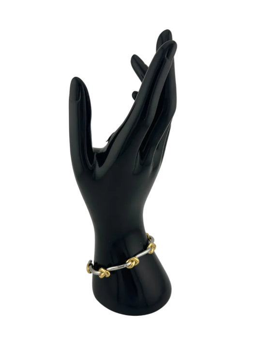 two tone bracelet shown on shiny black hand mannequin