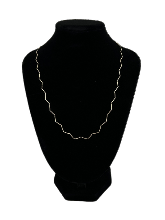 The Nova Zig Zag Choker shown on black velvet neckstand on white background
