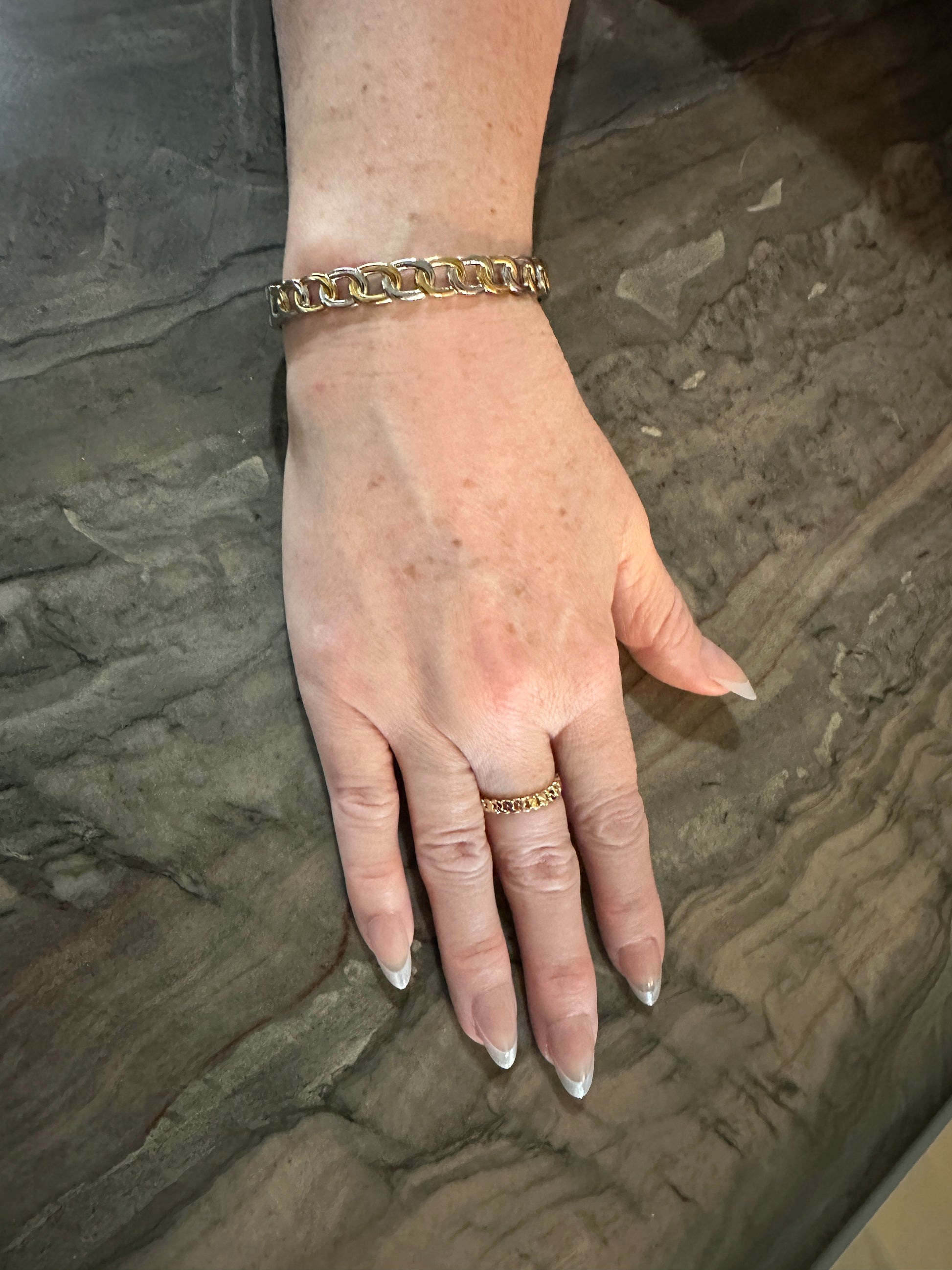 The Olivia Bangle Bracelet, modeled with the Cora Cuban Chain Ring